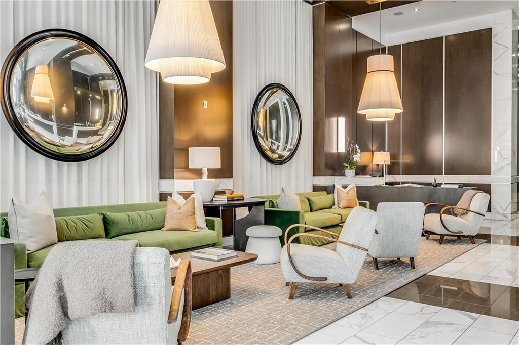 1820 Peachtree Road Northwest, Unit 1408 Atlanta, GA 30309 - Photo 25 of 37 a living room with couches a mirror and a large window