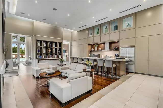 a living room with lots of furniture and kitchen view