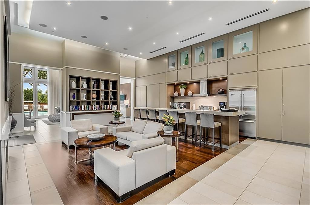 1820 Peachtree Road Northwest, Unit 1408 Atlanta, GA 30309 - Photo 28 of 37 a living room with stainless steel appliances kitchen island granite countertop a table chairs and a view of living room