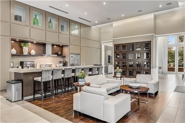 a living room with furniture a fireplace and a large window