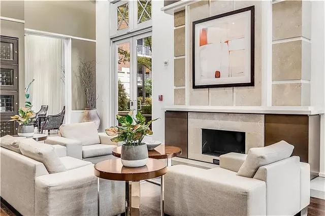 a living room with furniture and floor to ceiling windows