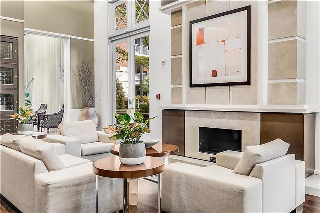 1820 Peachtree Road Northwest, Unit 1408 Atlanta, GA 30309 - Photo 30 of 37 a living room with furniture a fireplace and a large window