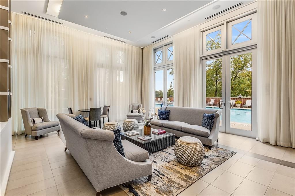 1820 Peachtree Road Northwest, Unit 1408 Atlanta, GA 30309 - Photo 31 of 37 a living room with furniture and floor to ceiling windows