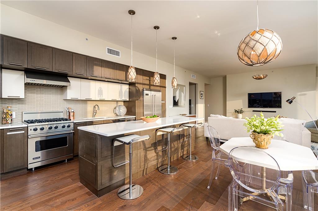 1820 Peachtree Road Northwest, Unit 1408 Atlanta, GA 30309 - Photo 4 of 37 a kitchen with a stove and a table