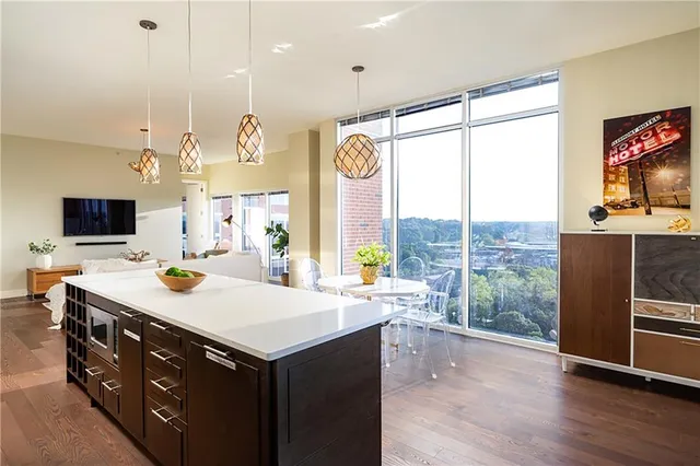 a kitchen with a sink a counter top space a stove and a large window