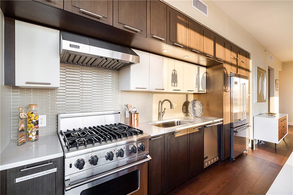 1820 Peachtree Road Northwest, Unit 1408 Atlanta, GA 30309 - Photo 10 of 37 a kitchen with stainless steel appliances a sink a stove and cabinets