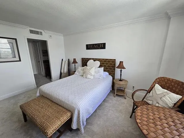 a bedroom with a bed lamp and window
