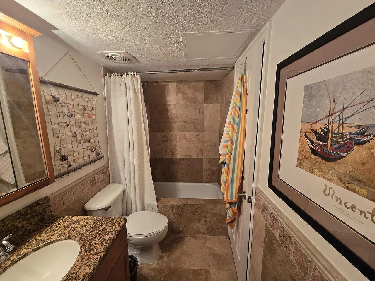 1900 South Ocean Boulevard, Unit 11L Lauderdale-by-the-Sea, FL 33062 - Photo 15 of 16 a bathroom with a sink toilet and shower