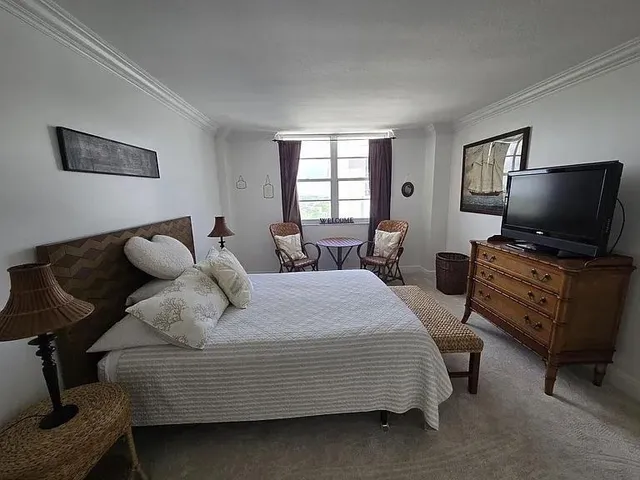 a bedroom with a bed and furniture with window