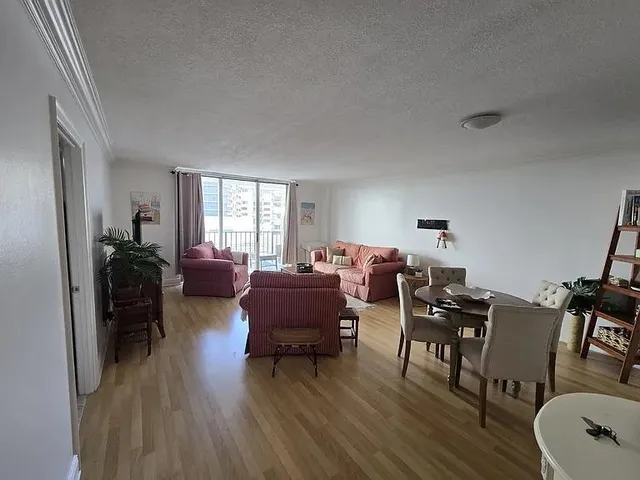 a living room with furniture a dining table with wooden floor and furniture