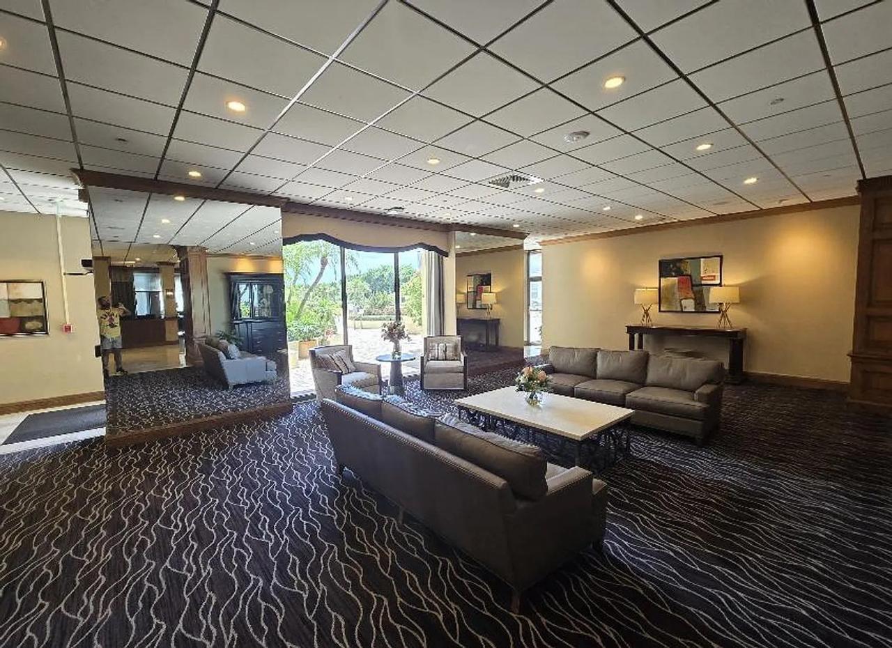 1900 South Ocean Boulevard, Unit 11L Lauderdale-by-the-Sea, FL 33062 - Photo 8 of 16 a living room with furniture and a wooden floor