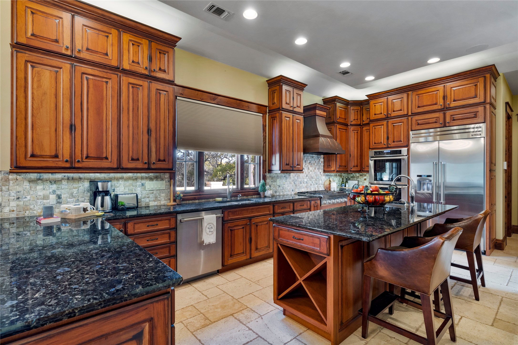 170 Goose Landing, Unit 10 57ACRES Harper, TX 78631 - Photo 22 of 40 a kitchen with stainless steel appliances granite countertop a sink and cabinets