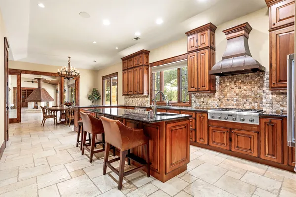 a kitchen with stainless steel appliances granite countertop a stove a sink dishwasher and cabinets