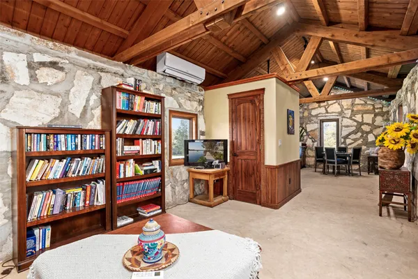 a living room with furniture and a book shelf