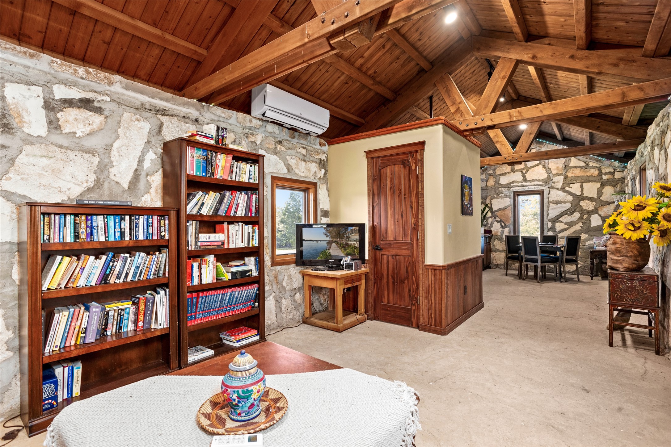 170 Goose Landing, Unit 10 57ACRES Harper, TX 78631 - Photo 31 of 40 a living room with furniture and a book shelf