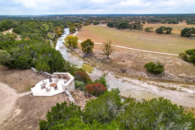 an aerial view of a house with a lake view
