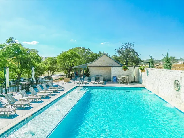 a view of a house with swimming pool and sitting area