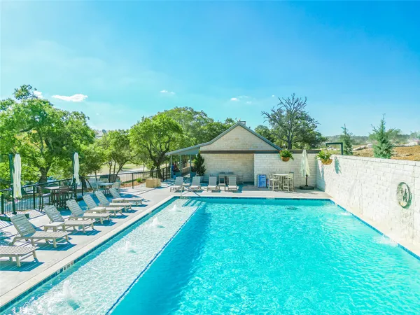 a view of a house with swimming pool and sitting area