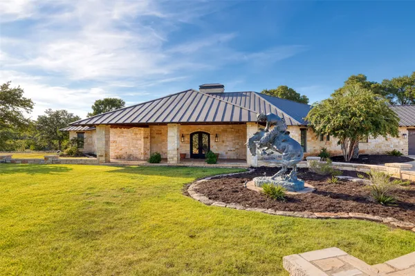 a front view of a house with garden