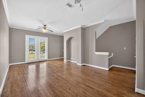 a view of a livingroom with a ceiling fan and window
