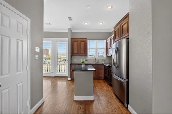 a spacious bathroom with a granite countertop sink a mirror and shower