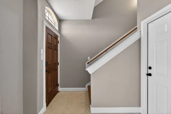 a kitchen with a refrigerator and wooden floor