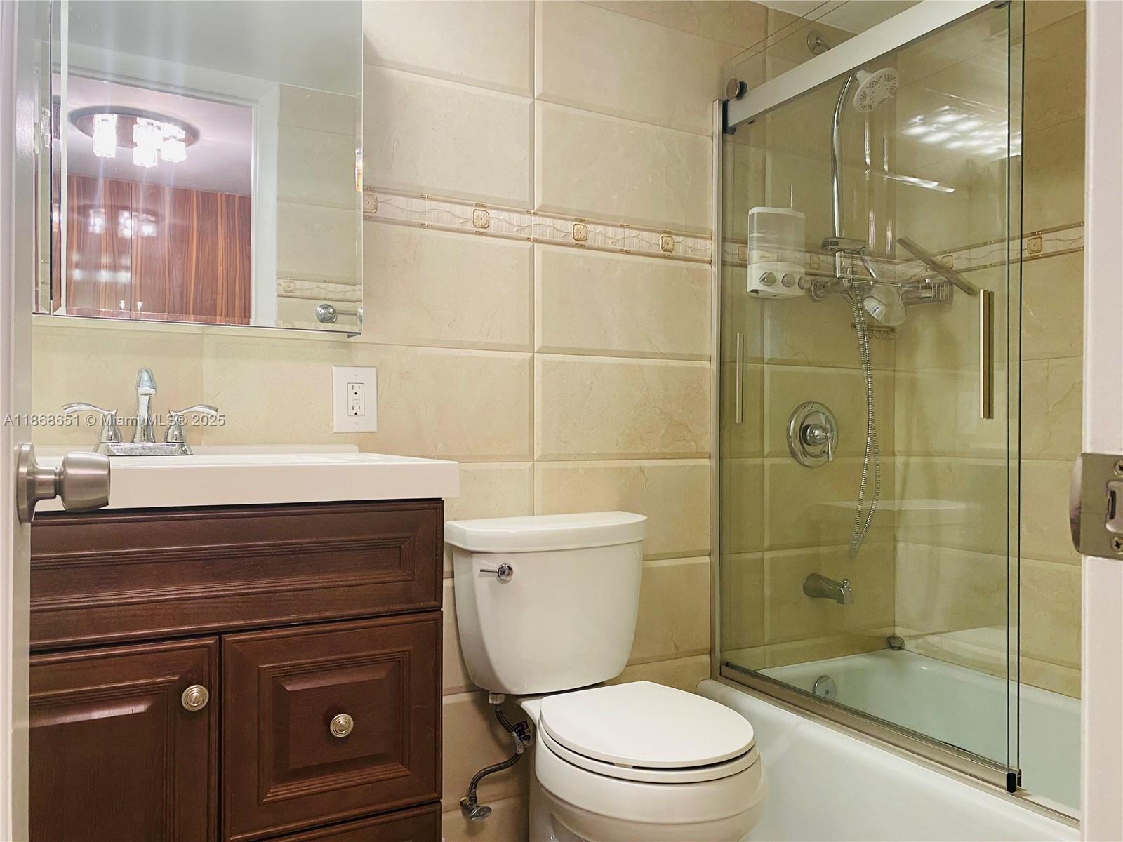 230 174th Street, Unit 507 Sunny Isles Beach, FL 33160 - Photo 14 of 28 a bathroom with a sink a toilet and shower
