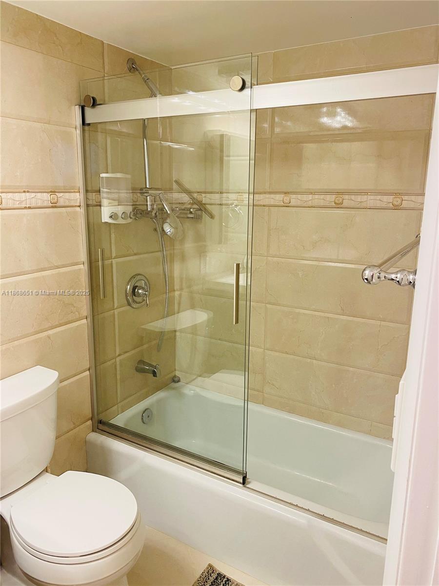 230 174th Street, Unit 507 Sunny Isles Beach, FL 33160 - Photo 15 of 28 a bathroom with a shower and a toilet