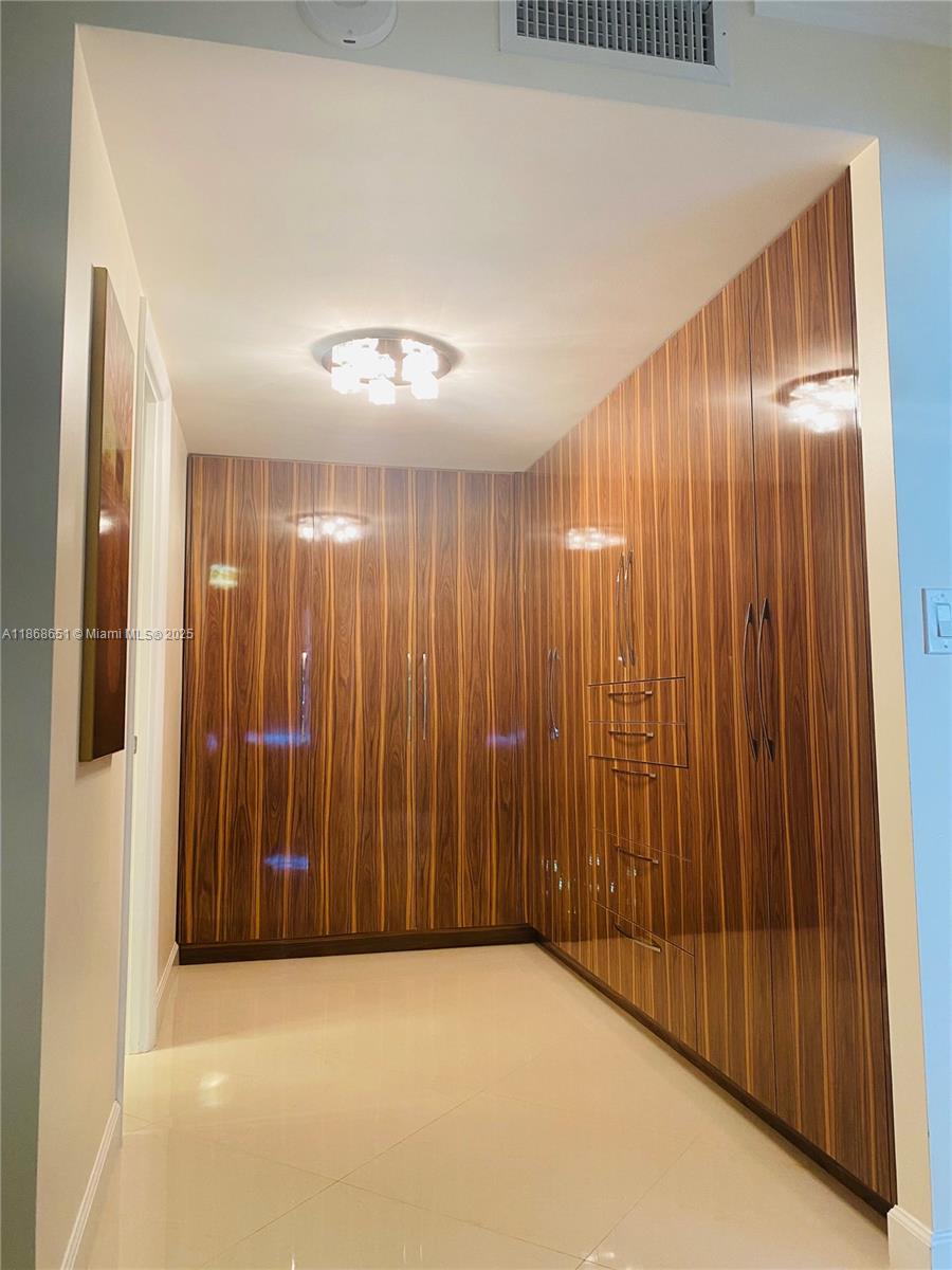 230 174th Street, Unit 507 Sunny Isles Beach, FL 33160 - Photo 16 of 28 an empty room with a elevator
