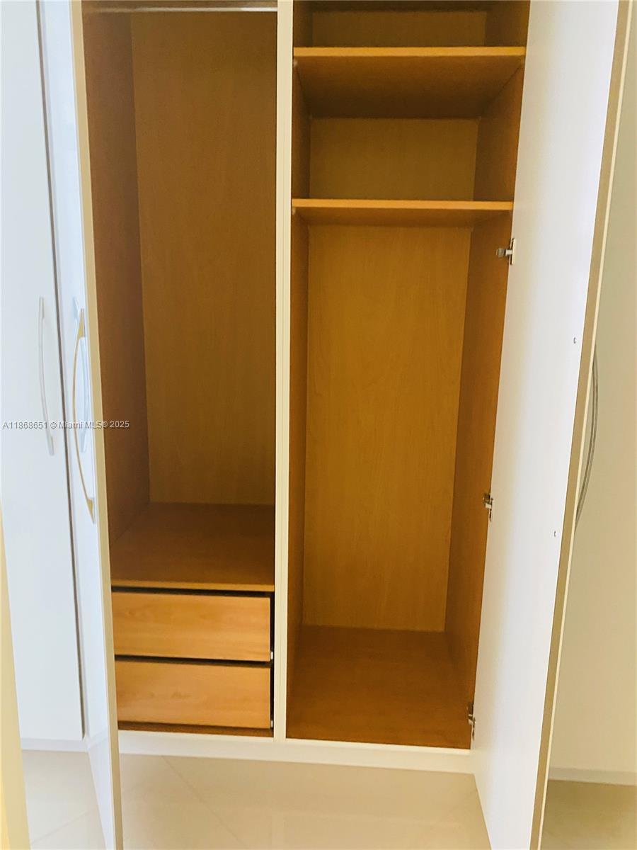 230 174th Street, Unit 507 Sunny Isles Beach, FL 33160 - Photo 20 of 28 a bathroom with a glass shower door