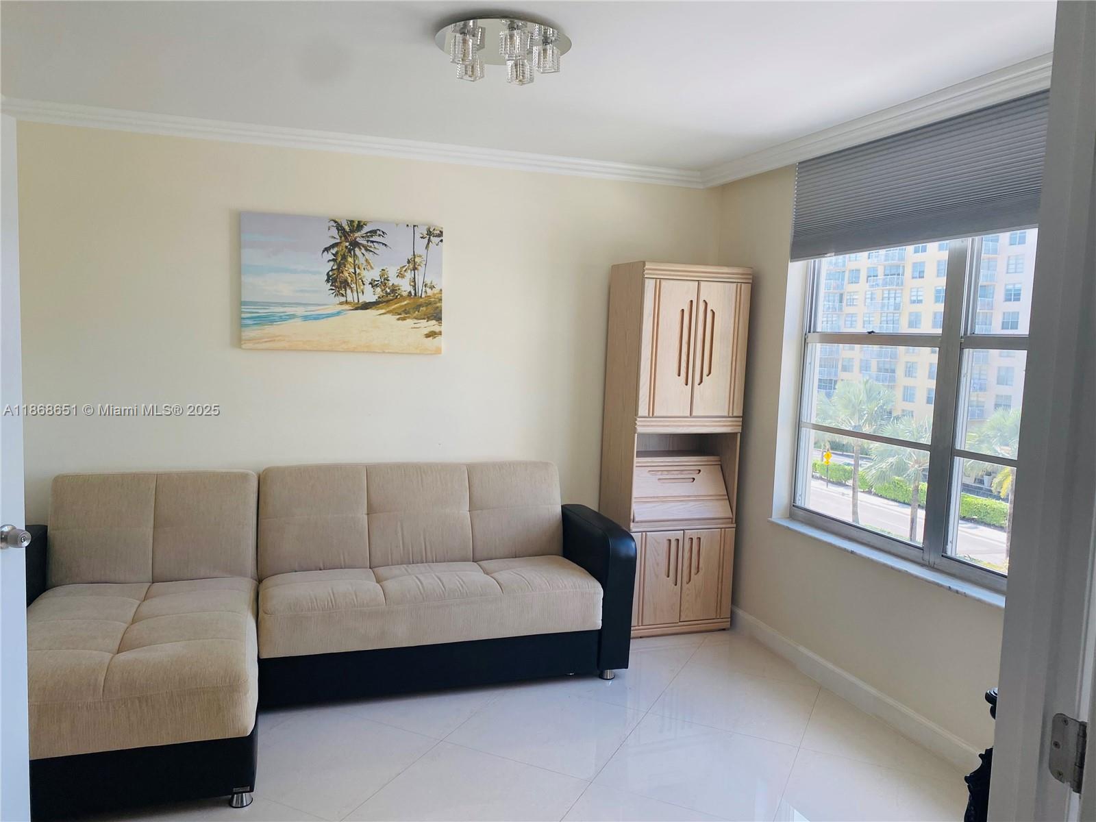 230 174th Street, Unit 507 Sunny Isles Beach, FL 33160 - Photo 23 of 28 a living room with furniture and a window