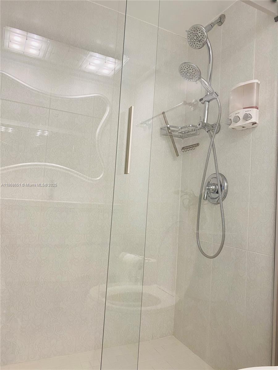 230 174th Street, Unit 507 Sunny Isles Beach, FL 33160 - Photo 25 of 28 a bathroom with a shower