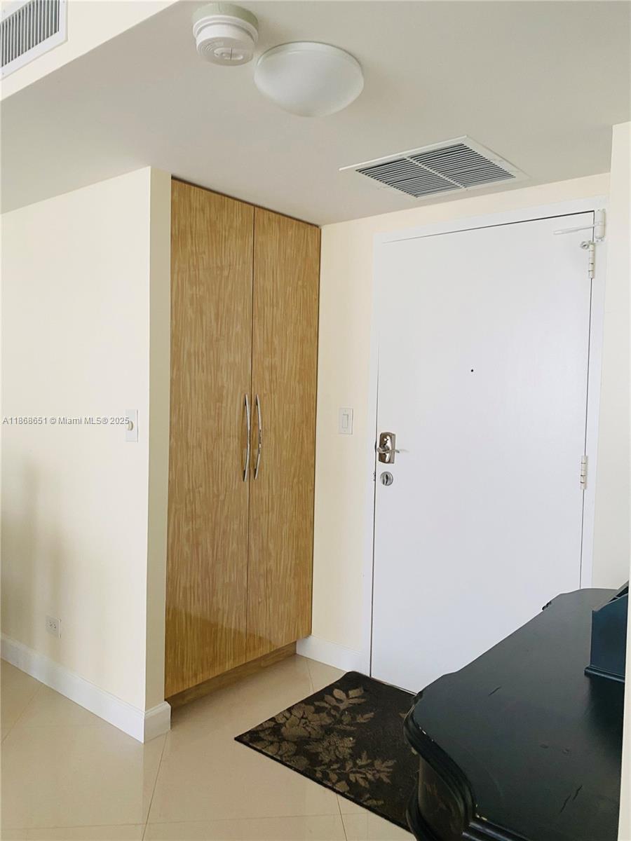 230 174th Street, Unit 507 Sunny Isles Beach, FL 33160 - Photo 3 of 28 a bedroom with a bed and a window