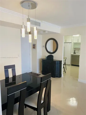 a living room with furniture a table and kitchen view