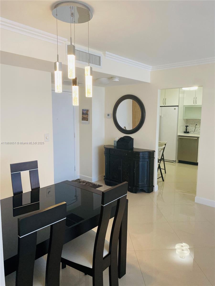 230 174th Street, Unit 507 Sunny Isles Beach, FL 33160 - Photo 6 of 28 a living room with furniture a table and kitchen view