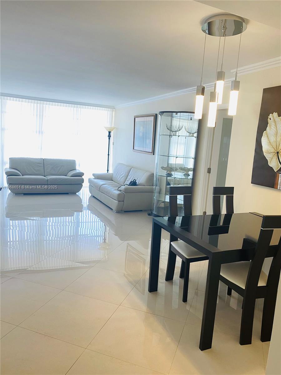 230 174th Street, Unit 507 Sunny Isles Beach, FL 33160 - Photo 8 of 28 a living room with furniture and wooden floor