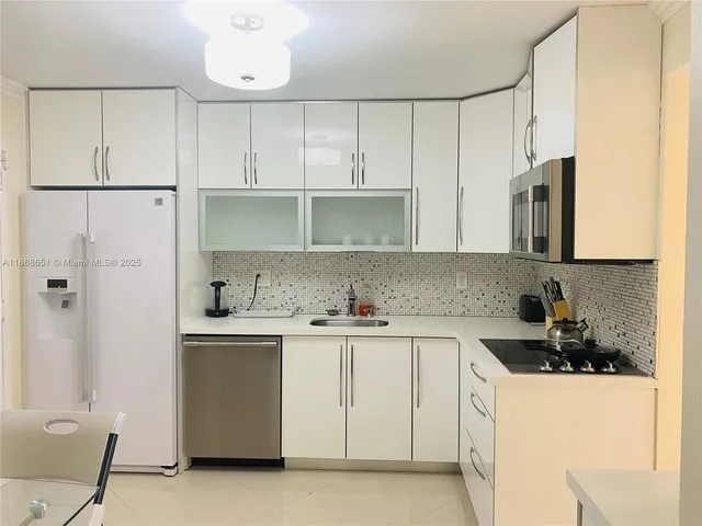 a kitchen with a sink a stove and cabinets