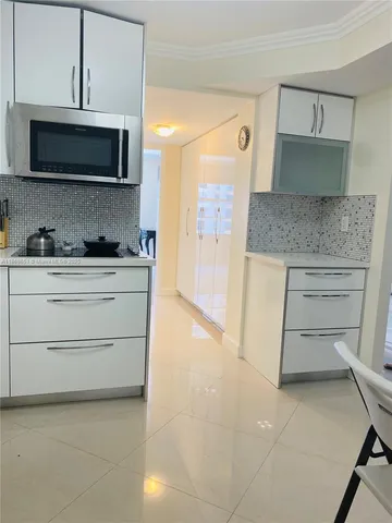 a kitchen with stainless steel appliances a stove and cabinets