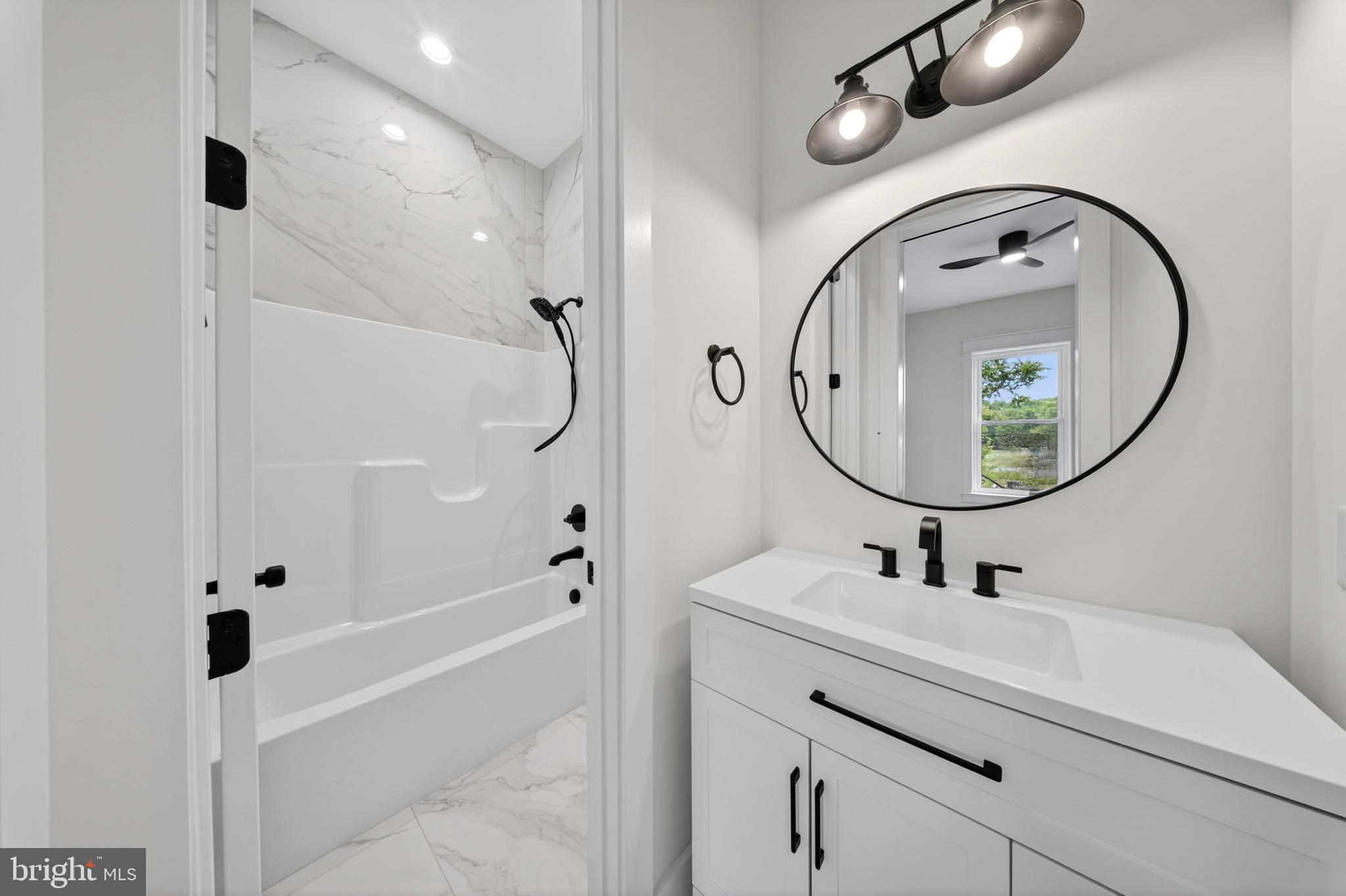 14133 Pepperbox Road Delmar, DE 19940 - Photo 44 of 59 a bathroom with a sink a toilet and a mirror