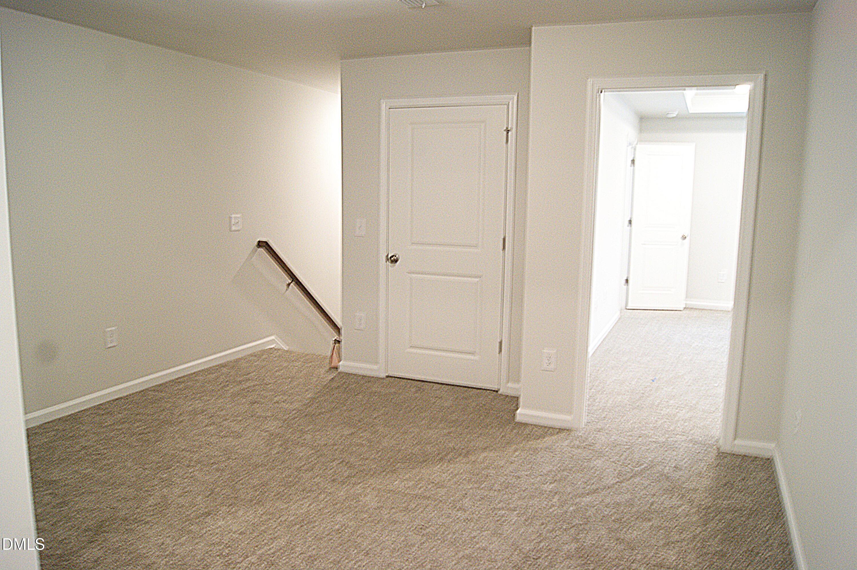 295 Glenmore Gardens Road Raleigh, NC 27603 - Photo 10 of 30 an empty room with a door