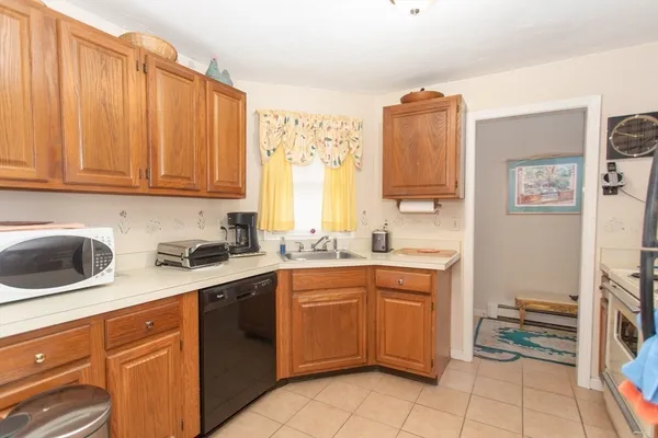 a kitchen with a sink a stove and a refrigerator
