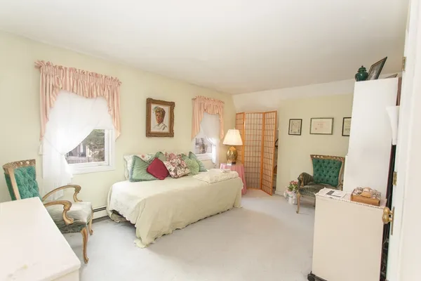 a bedroom with furniture and wooden floor