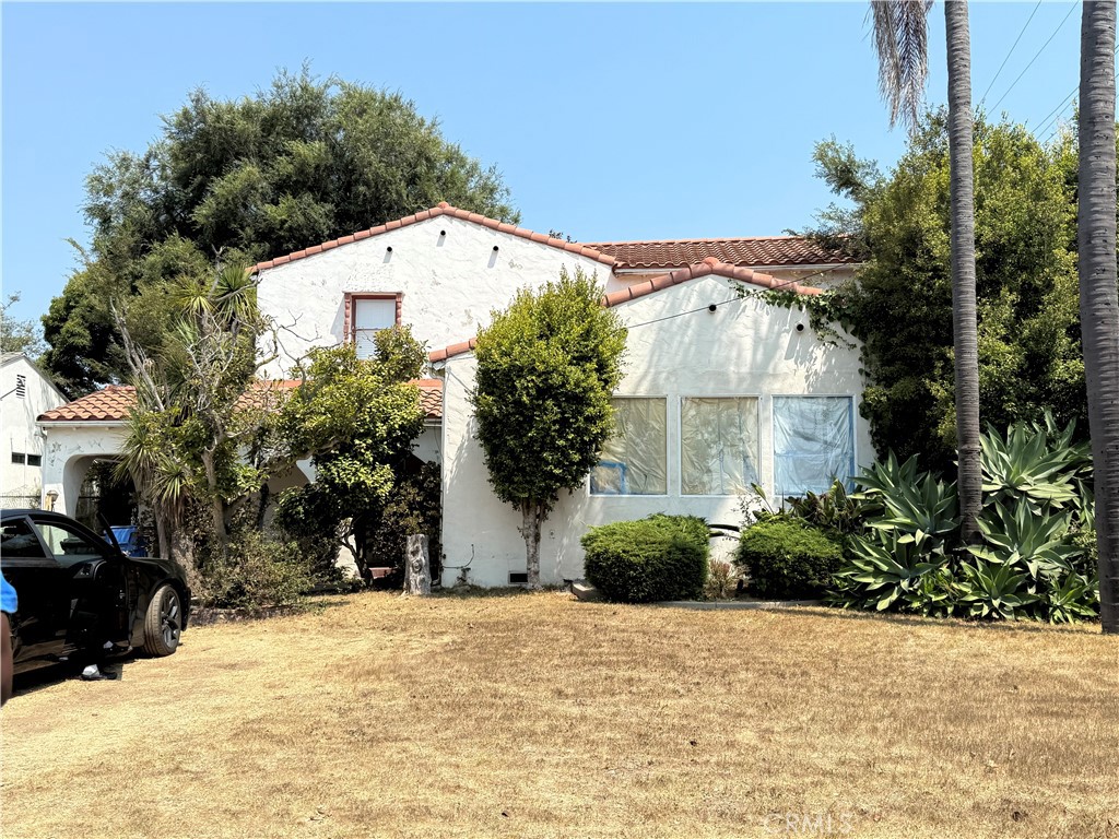 a view of a house with a yard covered with snow in the background