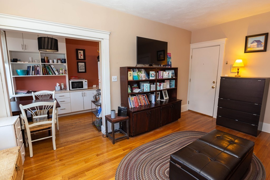 116 Sutherland Road, Unit 2 Boston, MA 02135 - Photo 4 of 10 a bedroom with furniture and a book shelf