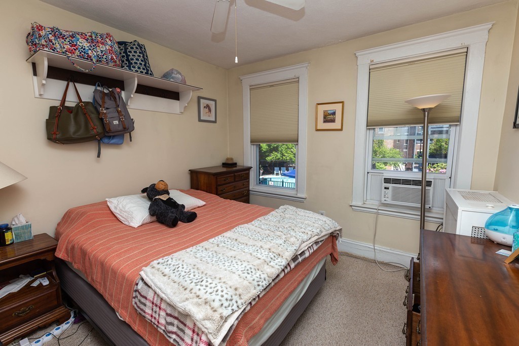 116 Sutherland Road, Unit 2 Boston, MA 02135 - Photo 8 of 10 a bedroom with a bed and wooden floor