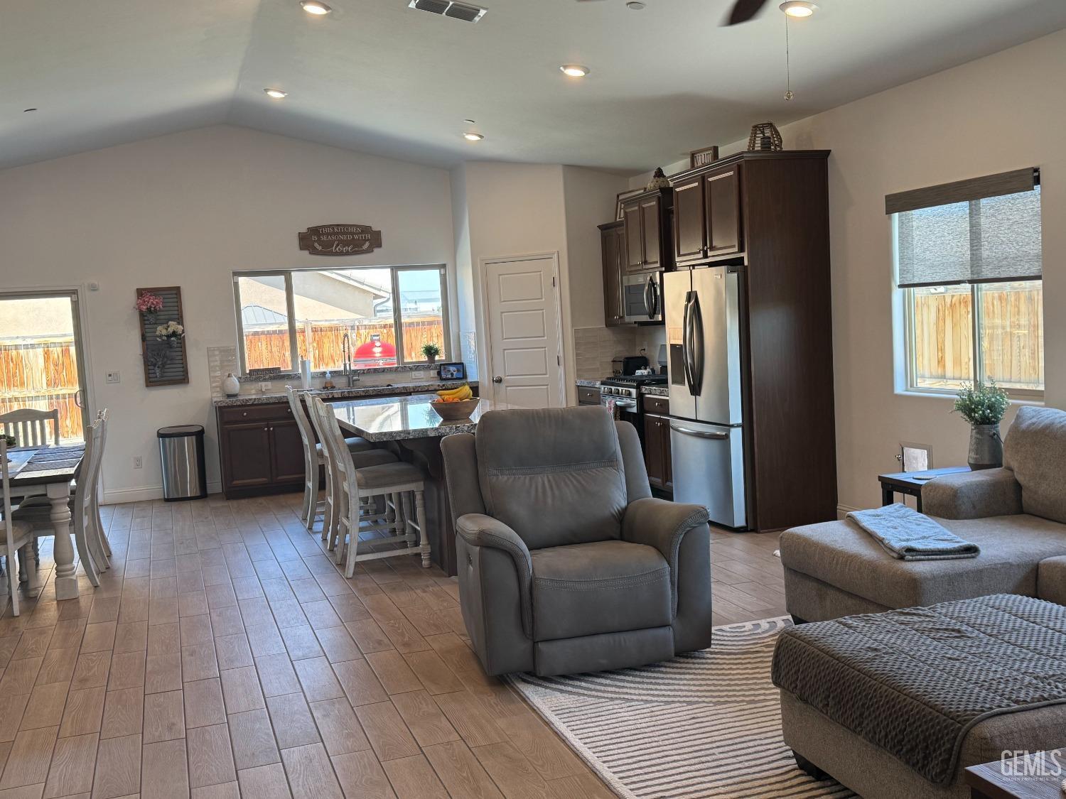 Undisclosed Address Shafter, CA 93263 - Photo 13 of 46 a living room with furniture a dining table and wooden floor