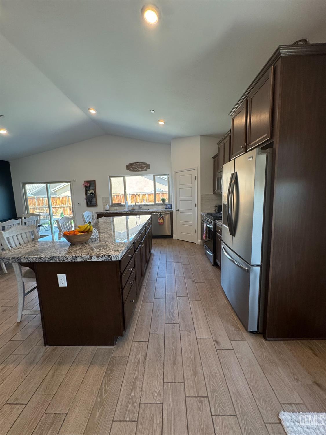 Undisclosed Address Shafter, CA 93263 - Photo 15 of 46 a kitchen with stainless steel appliances granite countertop a refrigerator a sink a stove and a wooden floors