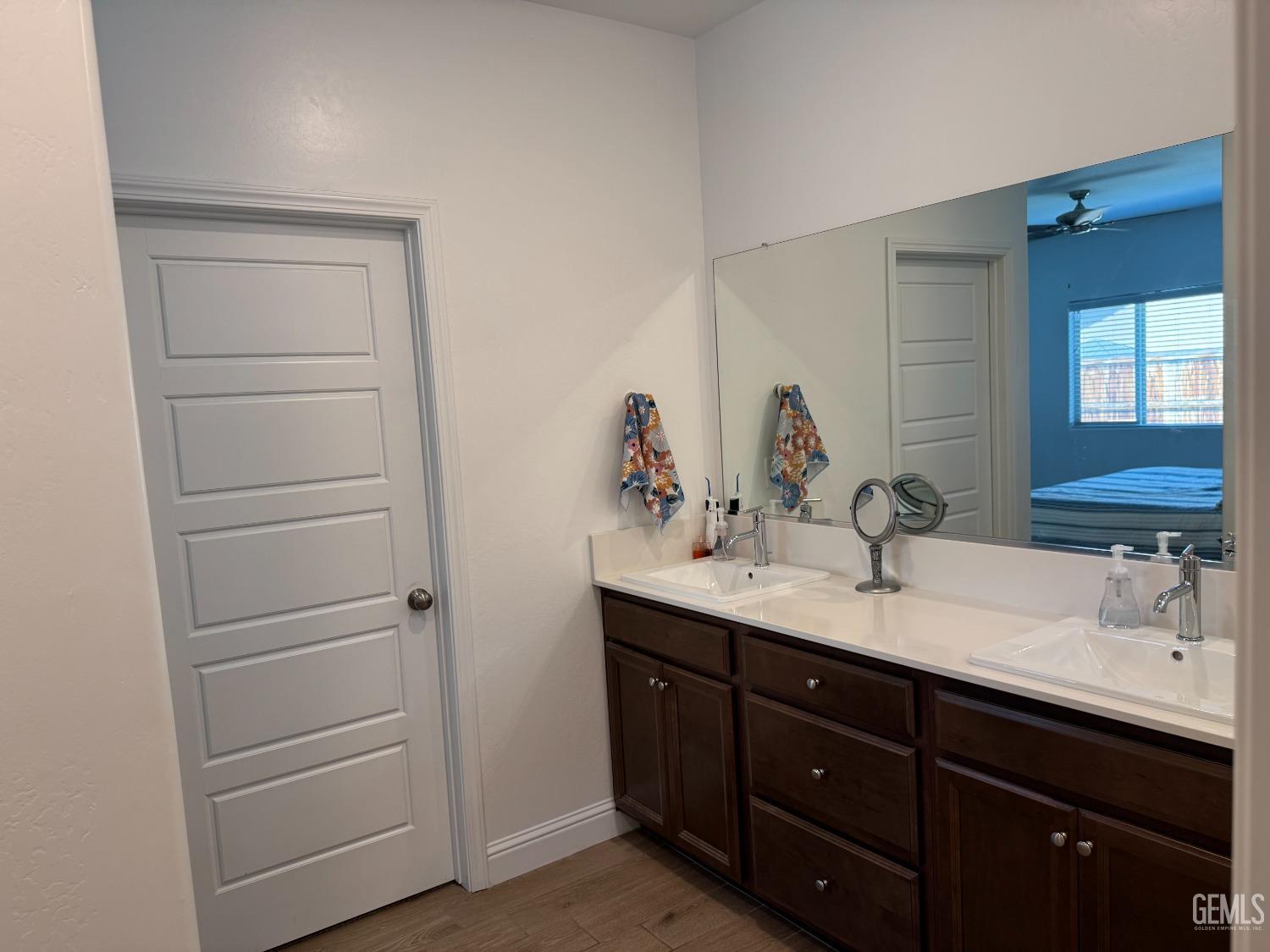 Undisclosed Address Shafter, CA 93263 - Photo 23 of 46 a bathroom with a double vanity sink and mirror