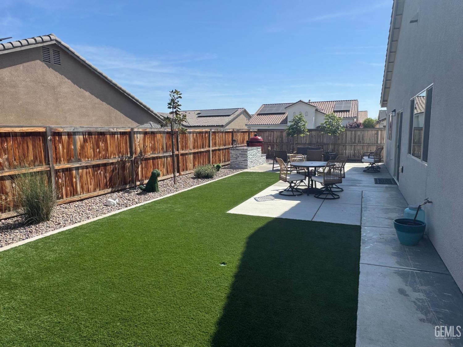 Undisclosed Address Shafter, CA 93263 - Photo 37 of 46 a view of a backyard with couches plants and wooden fence