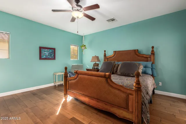 a bedroom with a bed and a chandelier